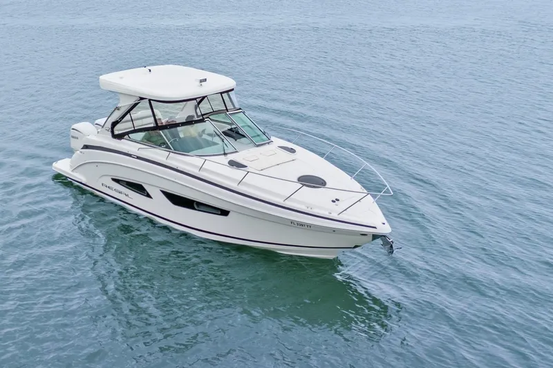 Sojourner Yacht Photos Pics 2024 Regal 33 XO boat cruising on calm blue water.