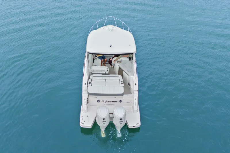 Sojourner Yacht Photos Pics 2024 Regal 33 XO boat on calm blue water, aerial view.