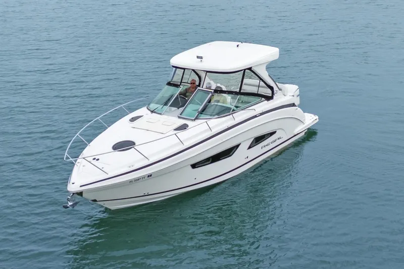 Sojourner Yacht Photos Pics 2024 Regal 33 XO boat on calm water, featuring sleek design and modern amenities.