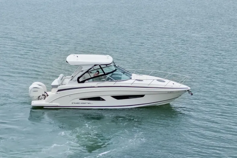 Sojourner Yacht Photos Pics 2024 Regal 33 XO boat cruising on calm waters.