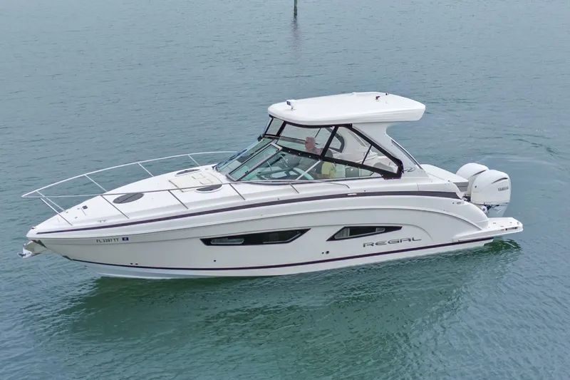 Sojourner Yacht Photos Pics 2024 Regal 33 XO boat on calm water, showcasing sleek design and modern features.