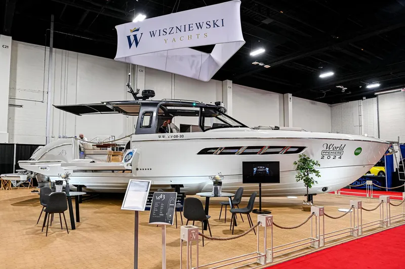  Yacht Photos Pics 2024 Wiszniewski Yachts W43 displayed at a boat show with promotional materials.
