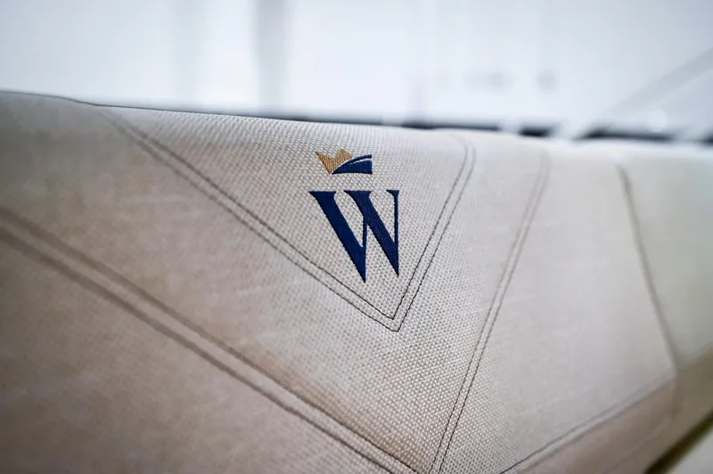  Yacht Photos Pics 2024 Wiszniewski Yachts W43 logo on beige upholstery, showcasing luxury craftsmanship.