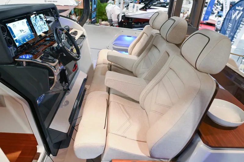  Yacht Photos Pics Luxurious 2024 Wiszniewski Yachts W43 cockpit with plush seating and advanced navigation controls.