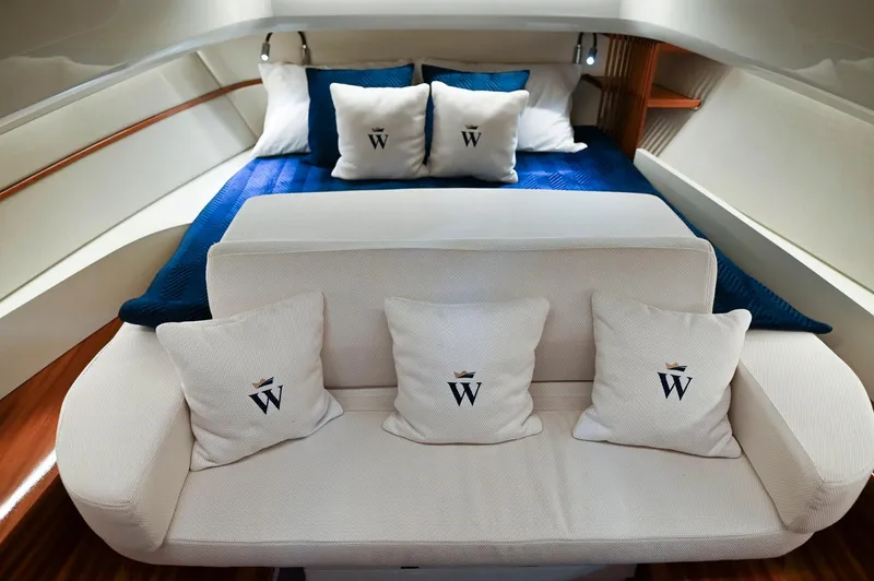  Yacht Photos Pics Luxurious interior of 2024 Wiszniewski Yachts W43, featuring elegant bedding and branded cushions.