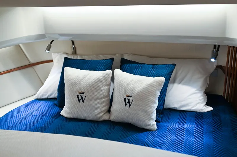  Yacht Photos Pics Luxurious 2024 Wiszniewski Yachts W43 cabin with elegant bedding and branded cushions.