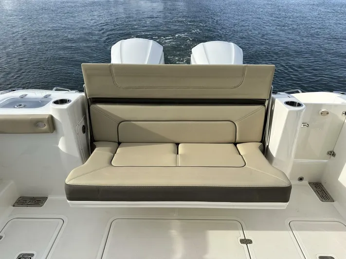 Always Grateful 2 Yacht Photos Pics 2021 Pursuit DC 326 Dual Console boat with beige seating, on calm water.