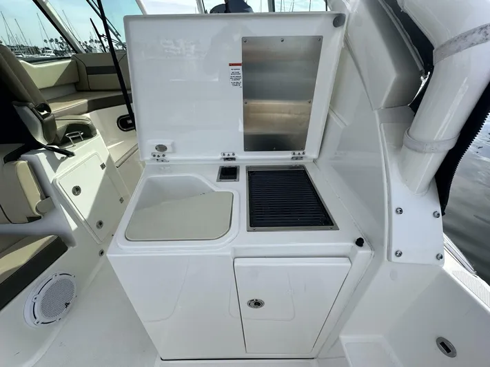 Always Grateful 2 Yacht Photos Pics 2021 Pursuit DC 326 Dual Console boat interior with grill and sink setup.