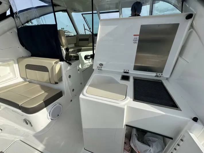 Always Grateful 2 Yacht Photos Pics 2021 Pursuit DC 326 Dual Console interior with seating and kitchenette area.
