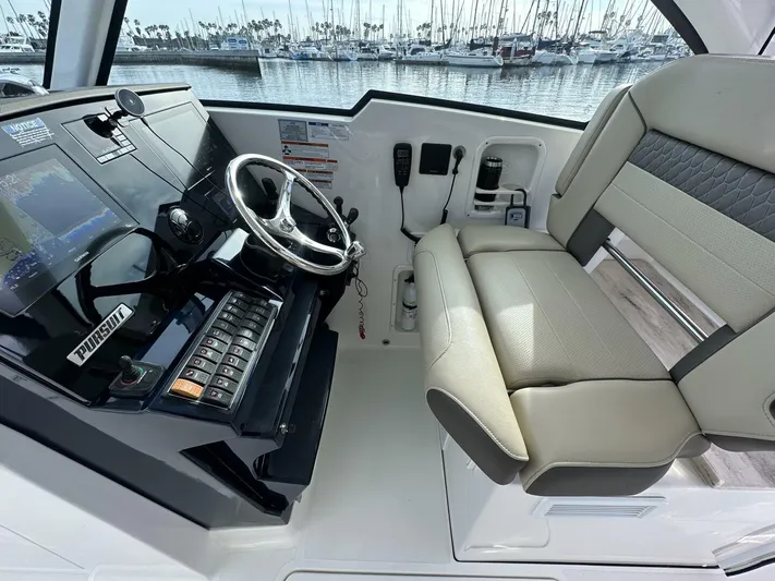 Always Grateful 2 Yacht Photos Pics 2021 Pursuit DC 326 Dual Console boat interior with steering wheel and control panel.