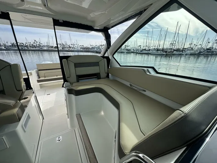 Always Grateful 2 Yacht Photos Pics 2021 Pursuit DC 326 Dual Console interior with marina view, featuring comfortable seating.