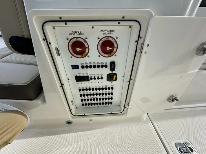 Always Grateful 2 Yacht Photos Pics Control panel of a 2021 Pursuit DC 326 Dual Console boat, featuring switches and gauges.