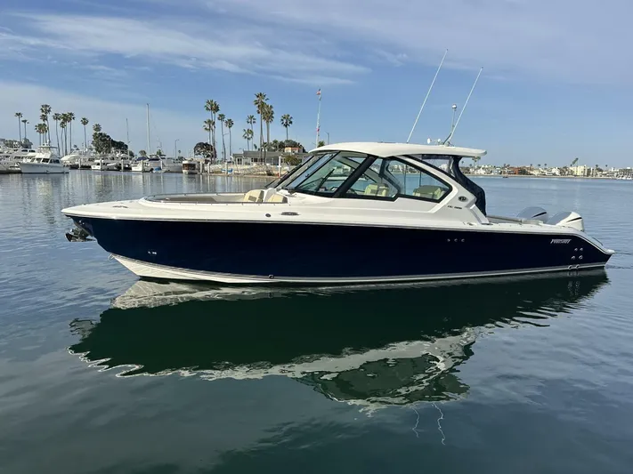 Always Grateful 2 Yacht Photos Pics 2021 Pursuit DC 326 Dual Console boat on calm water, clear sky background.