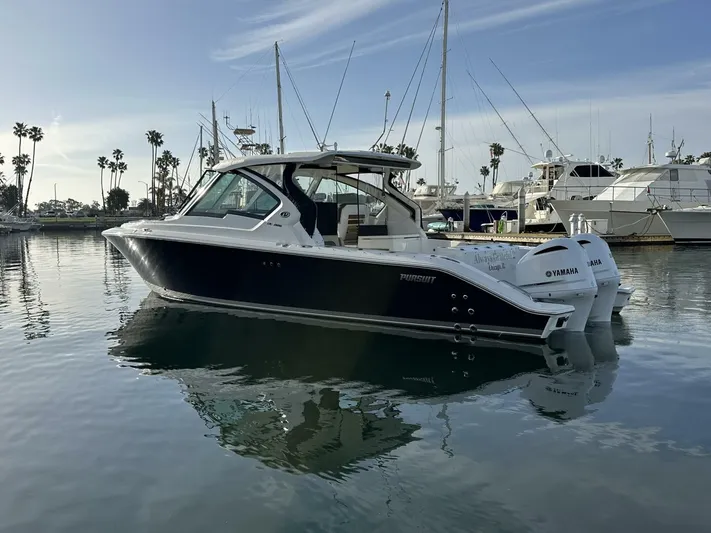 Always Grateful 2 Yacht Photos Pics 2021 Pursuit DC 326 Dual Console boat docked in a marina, calm water reflection.