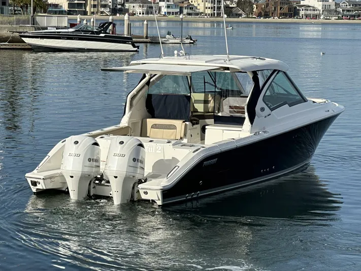 Always Grateful 2 Yacht Photos Pics 2021 Pursuit DC 326 Dual Console boat with twin engines on calm water.