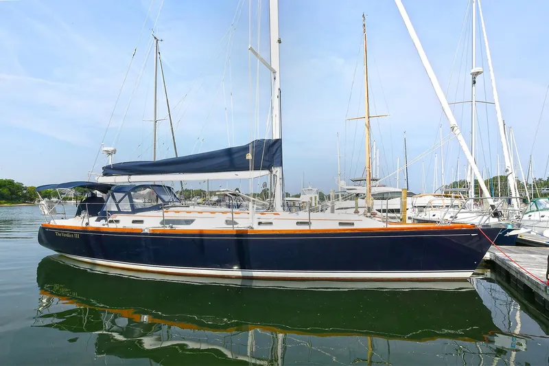 The Verdict III Yacht Photos Pics 2002 Sabre 452 sailboat docked in a marina, featuring a sleek blue hull.