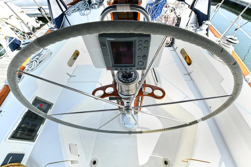 The Verdict III Yacht Photos Pics Steering wheel and navigation system on 2002 Sabre 452 sailboat deck.