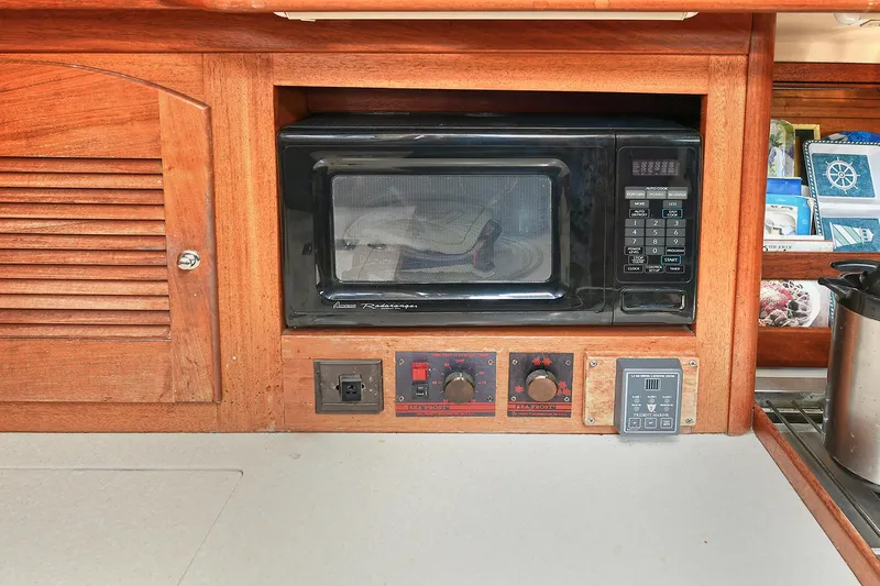 The Verdict III Yacht Photos Pics Wooden kitchen interior with built-in microwave in a 2002 Sabre 452 yacht.