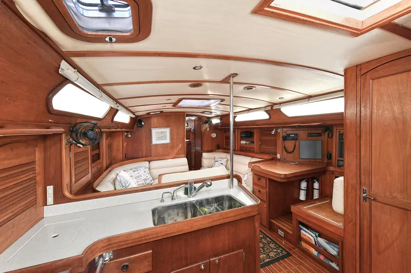 The Verdict III Yacht Photos Pics Interior of 2002 Sabre 452 yacht with wooden finish and cozy seating area.