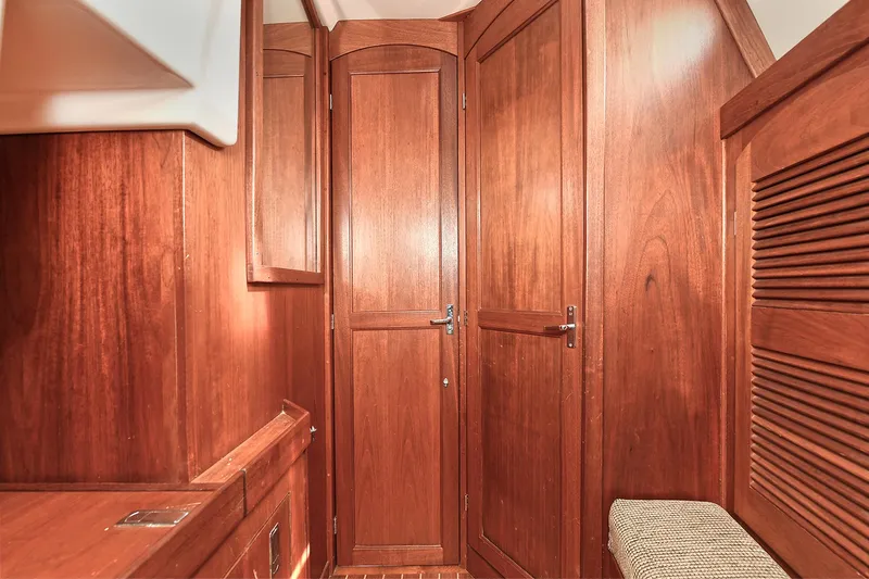 The Verdict III Yacht Photos Pics Wooden interior of 2002 Sabre 452 yacht, featuring elegant cabinetry and doors.