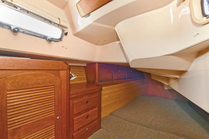 The Verdict III Yacht Photos Pics Interior cabin of 2002 Sabre 452 yacht with wooden cabinetry and carpeted flooring.