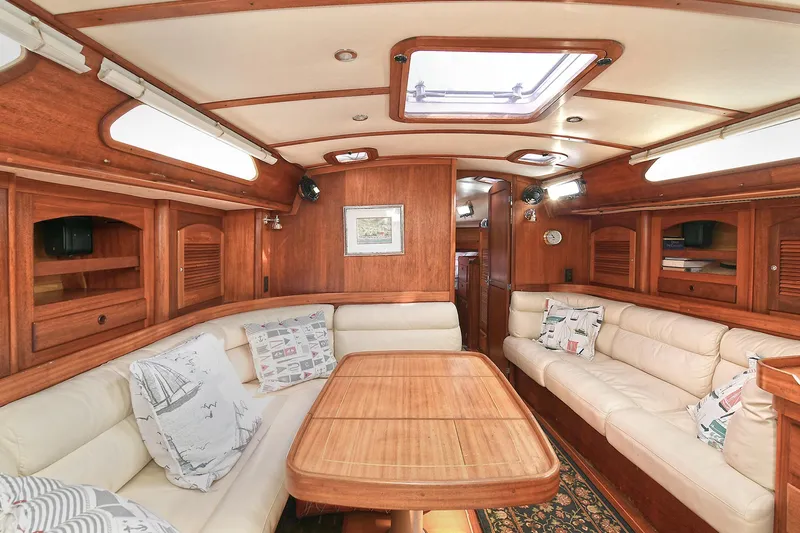 The Verdict III Yacht Photos Pics Luxurious interior of 2002 Sabre 452 yacht with wooden finish and plush seating.