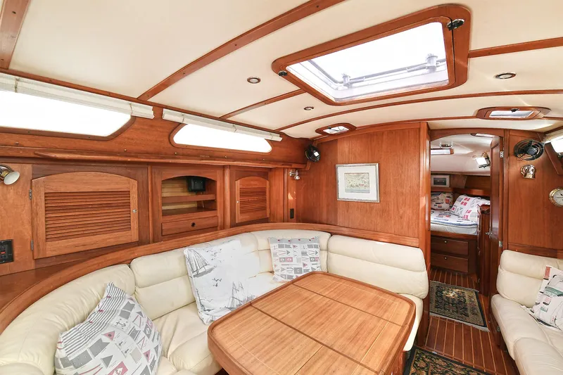 The Verdict III Yacht Photos Pics Luxurious 2002 Sabre 452 yacht interior with wood finish and cozy seating area.