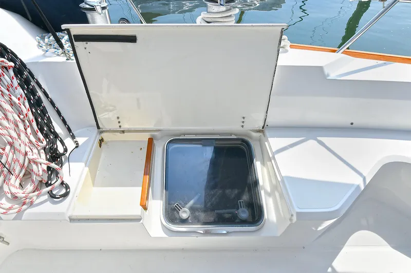The Verdict III Yacht Photos Pics Open hatch on 2002 Sabre 452 sailboat deck with ropes and storage compartment.
