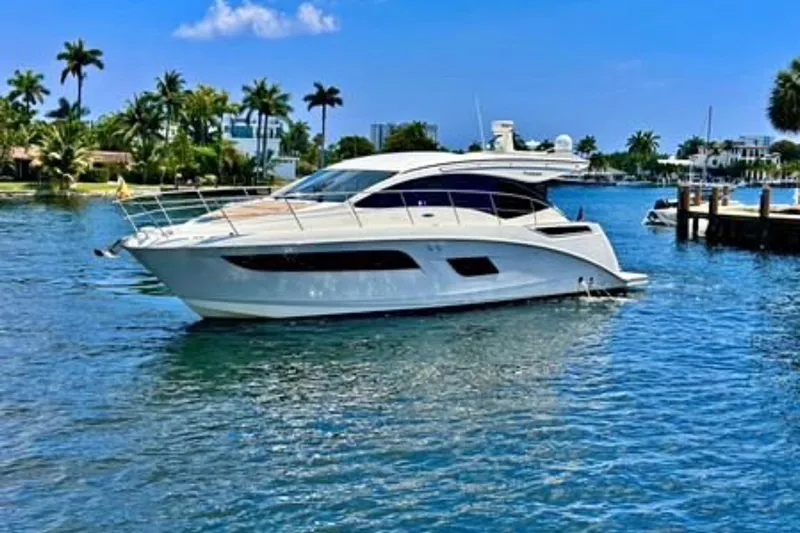  Yacht Photos Pics 2016 Sea Ray 400 Sundancer yacht on clear blue water, surrounded by palm trees.