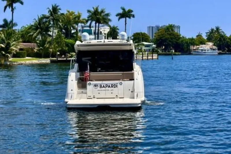  Yacht Photos Pics 2016 Sea Ray 400 Sundancer yacht cruising on a sunny, palm-lined waterway.
