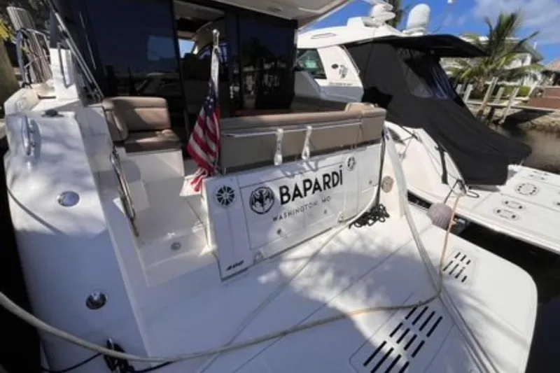  Yacht Photos Pics 2016 Sea Ray 400 Sundancer yacht docked, featuring American flag and "Bapardi" nameplate.
