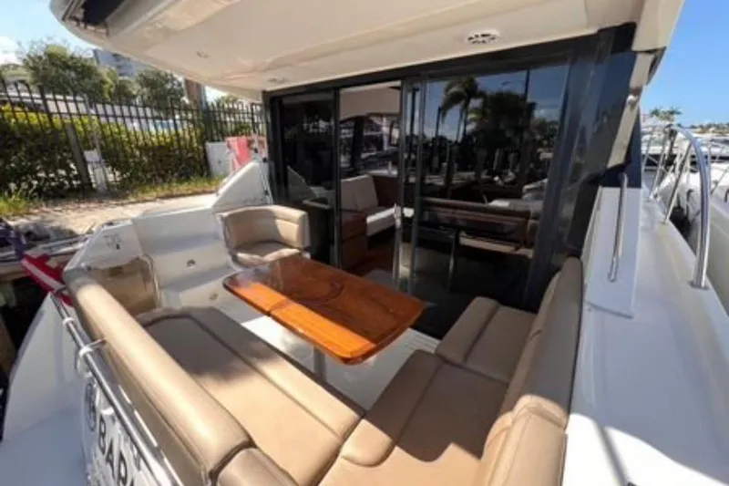  Yacht Photos Pics 2016 Sea Ray 400 Sundancer yacht with outdoor seating and wooden table.