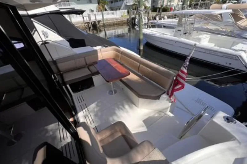  Yacht Photos Pics 2016 Sea Ray 400 Sundancer yacht with spacious deck and seating area, docked at marina.