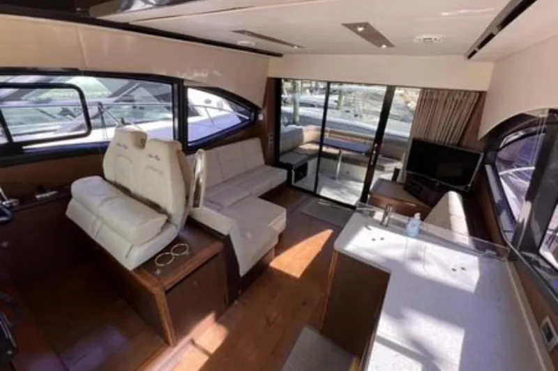  Yacht Photos Pics Luxurious interior of 2016 Sea Ray 400 Sundancer yacht with modern seating and entertainment area.