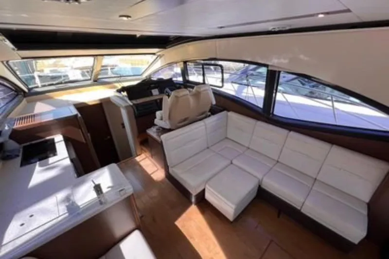  Yacht Photos Pics Luxurious interior of 2016 Sea Ray 400 Sundancer yacht with white seating and modern design.