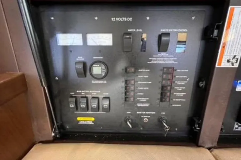  Yacht Photos Pics Control panel of a 2016 Sea Ray 400 Sundancer boat, featuring various switches and gauges.