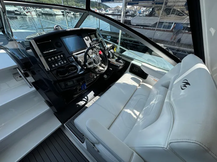  Yacht Photos Pics Cockpit of 2019 Monterey 335 SY boat with modern controls and white seating.