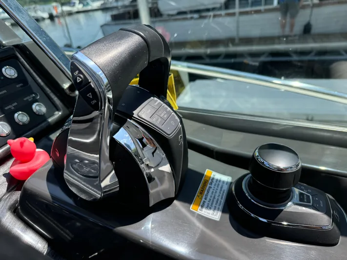  Yacht Photos Pics Control panel of a 2019 Monterey 335 SY boat with throttle and joystick.