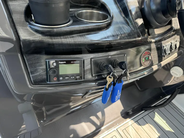  Yacht Photos Pics Control panel of a 2019 Monterey 335 SY boat with keys and audio system.