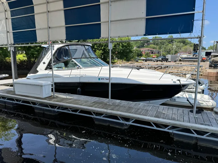  Yacht Photos Pics 2019 Monterey 335 SY boat docked under a striped canopy.