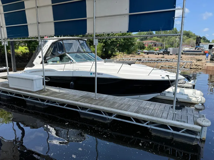  Yacht Photos Pics 2019 Monterey 335 SY boat docked under a canopy on a sunny day.