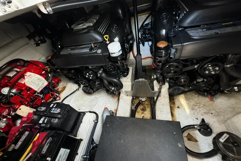  Yacht Photos Pics Engine room of a 2019 Monterey 335 SY boat, showcasing dual engines and battery setup.