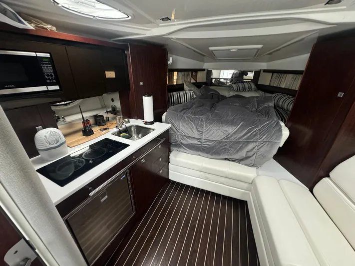  Yacht Photos Pics Luxurious interior of a 2019 Monterey 335 SY yacht with kitchen and cozy sleeping area.