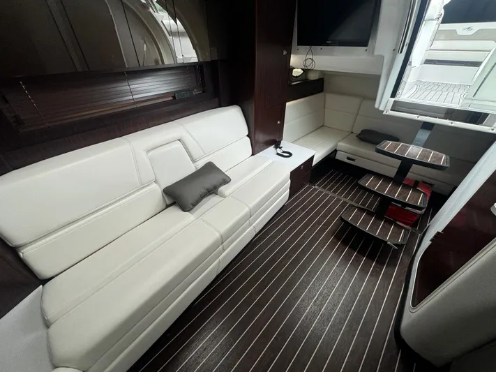  Yacht Photos Pics Luxurious interior of a 2019 Monterey 335 SY yacht with white seating and wooden flooring.
