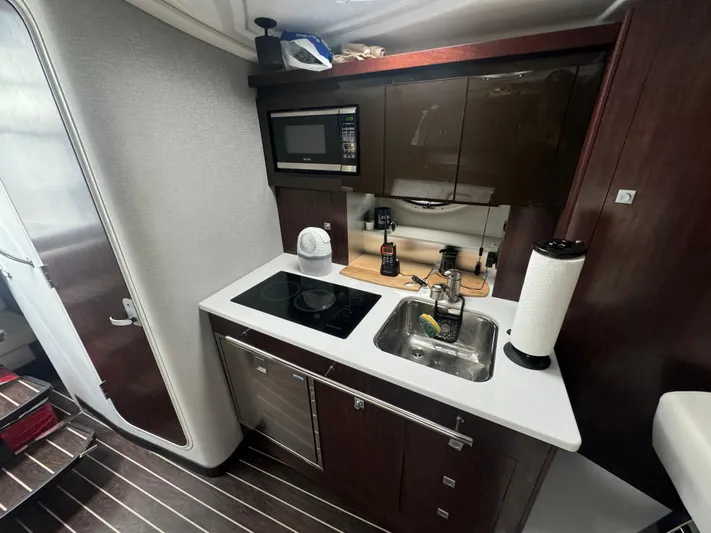  Yacht Photos Pics Compact kitchen in 2019 Monterey 335 SY yacht with modern appliances and sleek design.