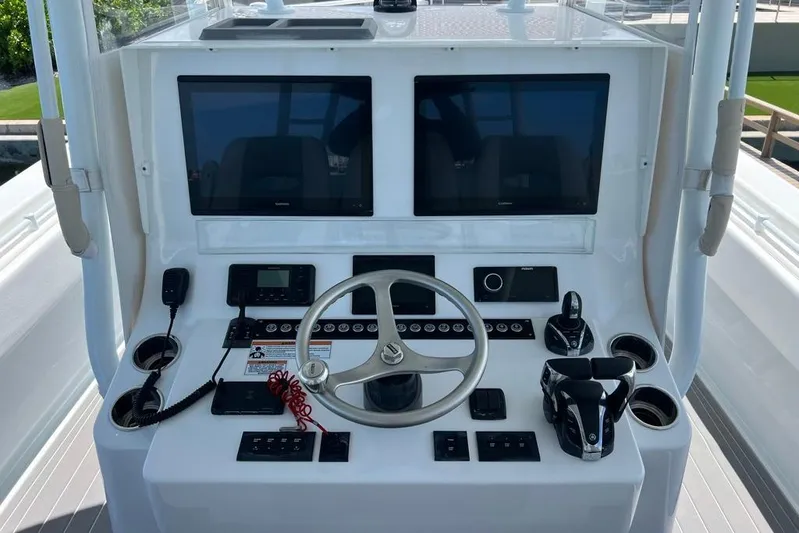  Yacht Photos Pics 2023 Contender 39 ST boat dashboard with dual screens and steering wheel.