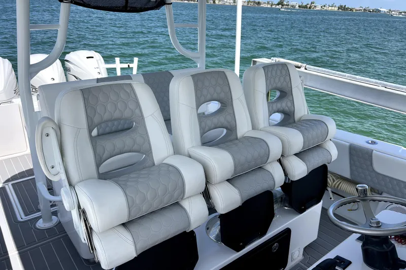  Yacht Photos Pics 2023 Contender 39 ST boat with luxurious seating, overlooking a scenic ocean view.