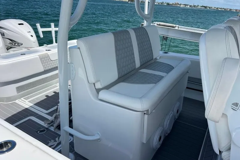  Yacht Photos Pics 2023 Contender 39 ST boat interior with cushioned seating and Yamaha XTO outboard engine.
