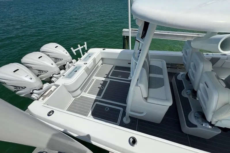  Yacht Photos Pics 2023 Contender 39 ST boat with triple outboard engines, sleek seating, and modern deck design.