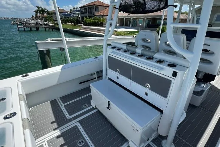  Yacht Photos Pics 2023 Contender 39 ST boat interior with seating and storage, docked by waterfront homes.